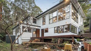 A two-story house with a large front porch, multiple windows, and a brick foundation. - Casa Vista, Dandenong Ranges forest retreat (Kalorama)