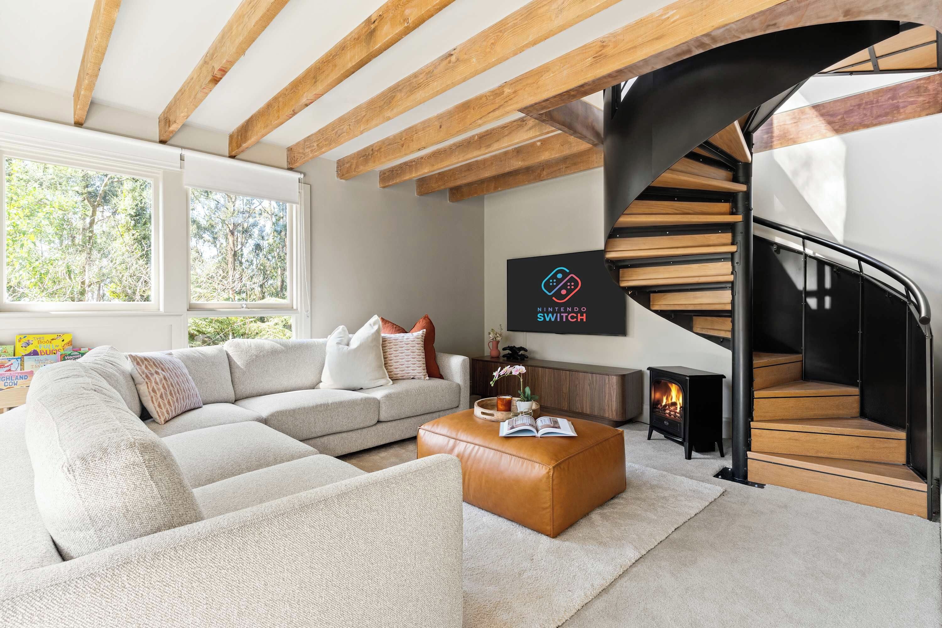 A modern living room with a sofa, coffee table, and a fireplace.