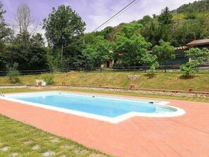 A rectangular swimming pool with a tiled deck, surrounded by a grassy area and trees. - Casa Fronda B: A graceful apartment that is part of an ancient country house situated at a short distance from the shores of Lake Piediluco, with Free WI-FI. (Terni)