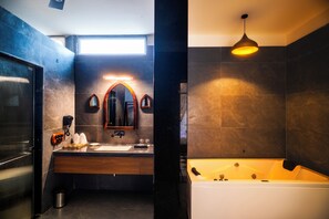 A modern bathroom with a large mirror, a sink, and a bathtub. - The Talhati (Kumbhalgarh)