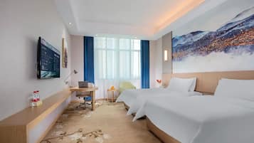 A hotel room with a bed, a desk, a chair, a TV, and a large window with curtains.