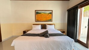 A hotel room with a large bed, a painting on the wall, and a view through the window. - BUBU Villa Ubud  (Ubud)
