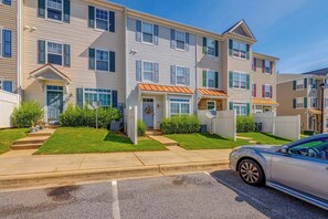 A row of townhouses with front porches, satellite dishes, and a car parked on the street. - Home Gym & Pool Access! North Raleigh Retreat (Raleigh)