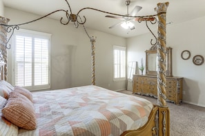 A bedroom with a four-poster bed, a ceiling fan, a dresser, and a mirror. - Grill & Yard! Family Escape, 8 Mi to Dtwn Odessa (Odessa)