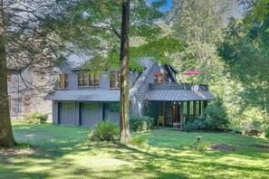 A two-story house with a sloped roof, a covered porch, and a stone foundation. - Deck & Wooded Views! 2 Mi to Frederick Gunn School (Washington)