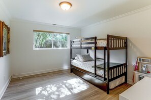 A room with a bunk bed, a window with a view of trees, and a small kitchenette area. - 1 Mi to Courthouse Plaza! Home w/ Deck + Fireplace (Prescott)