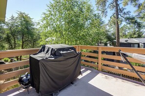 A covered barbecue grill on a balcony with a view of trees and a building in the background. - 1 Mi to Courthouse Plaza! Home w/ Deck + Fireplace (Prescott)