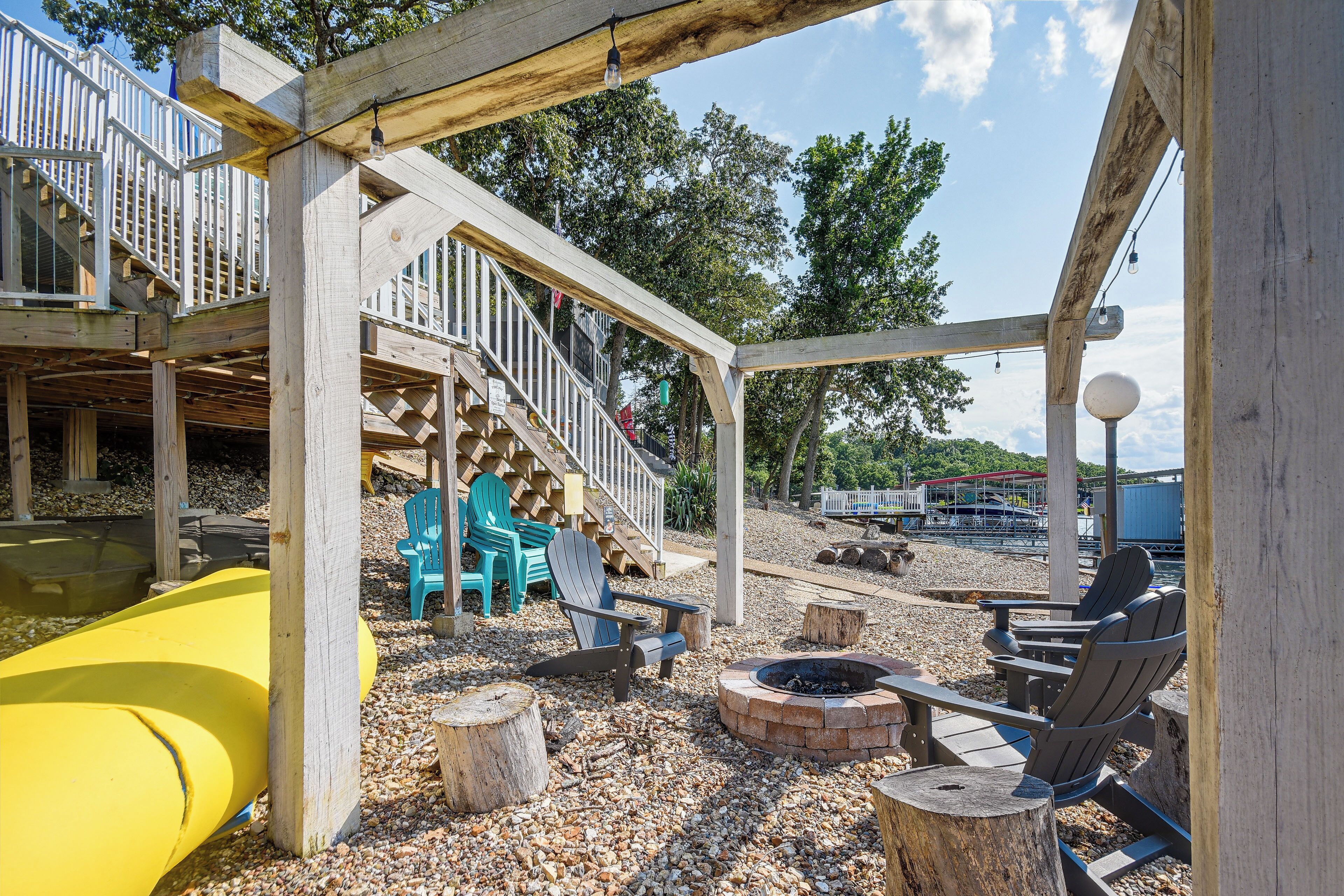 A wooden deck with a slide, outdoor seating, and a fire pit.