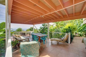 An outdoor patio with a wooden pergola, a dining table with chairs, a sofa, and a lounge chair. - Ocean-View Group Retreat! 8 Mi to Magic Sands (Holualoa)