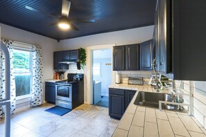 A modern kitchen with a built-in oven, a stove, and a sink.