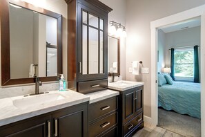 A bathroom with two sinks, a large mirror, and a cabinet with drawers. - Near Parks & Dtwn Clarinda! 'House of Stroburg' (Clarinda)