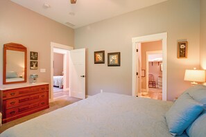 A bedroom with a bed, dresser, and a door leading to another room. - Near Parks & Dtwn Clarinda! 'House of Stroburg' (Clarinda)