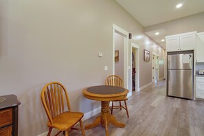 A kitchen with a stainless steel refrigerator, wooden chairs, and a dining table. - Near Parks & Dtwn Clarinda! 'House of Stroburg' (Clarinda)