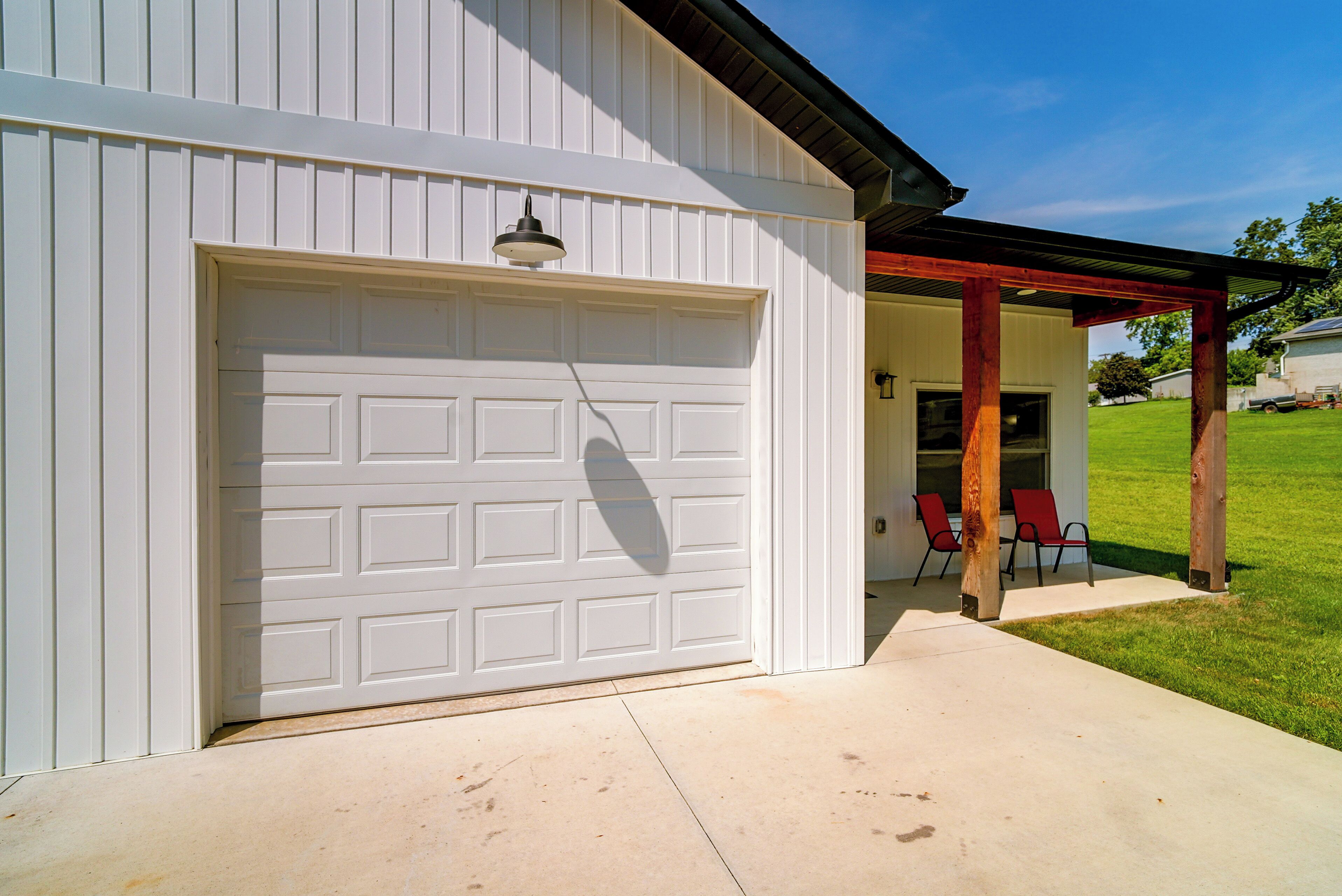 A garage door with a light fixture above it.