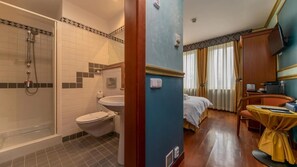 A hotel bathroom with a shower, toilet, and sink. - Kinsky Fountain (Hlavní město Praha)