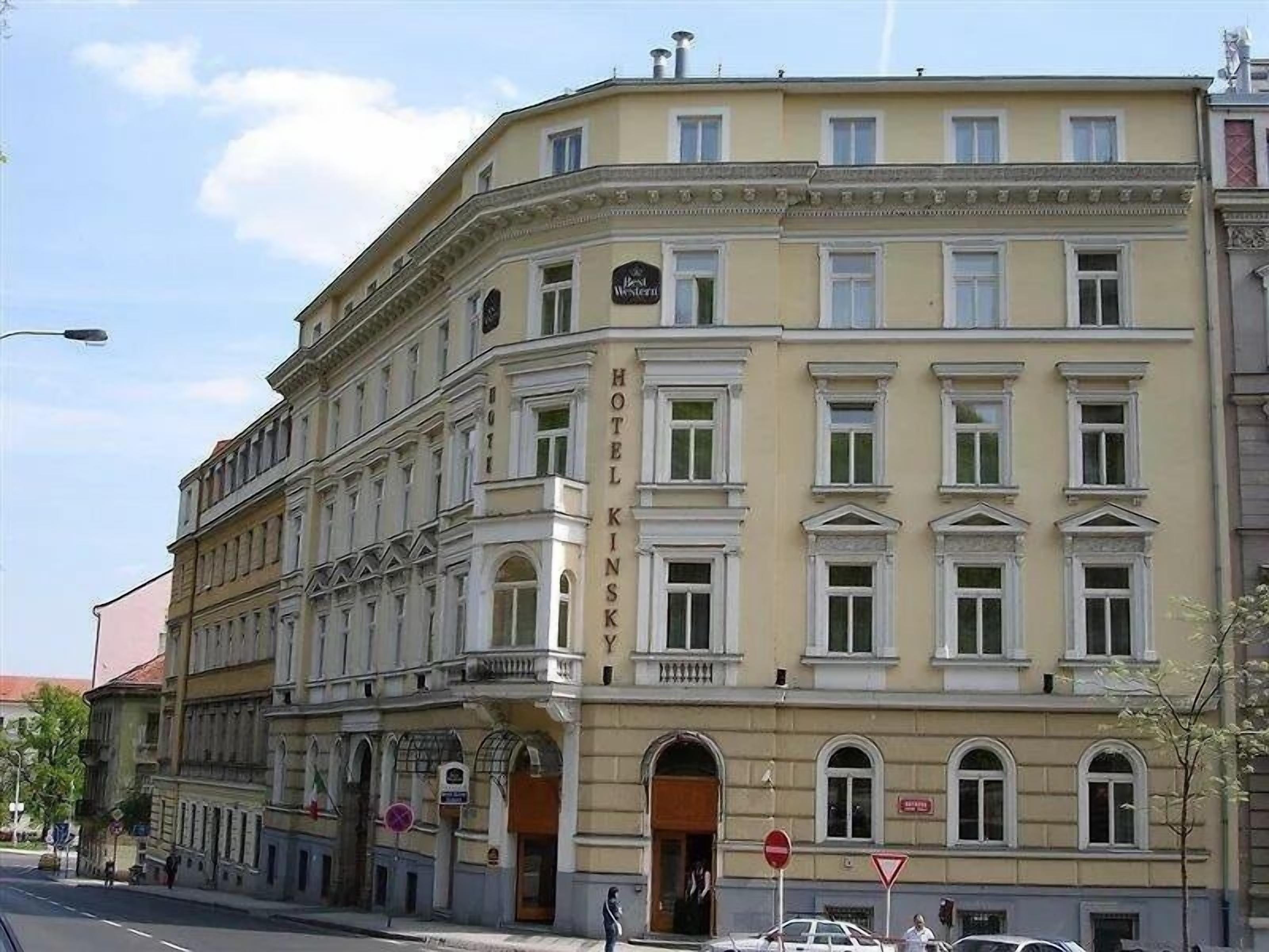 A multi-story hotel with a classic architectural style, featuring a prominent entrance and balconies.