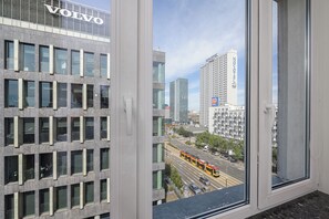 A cityscape with modern buildings, including a hotel named Novotel, and a tram in the foreground. - Lumina 2room Apart with Balcony 6 guests (Warszawa)