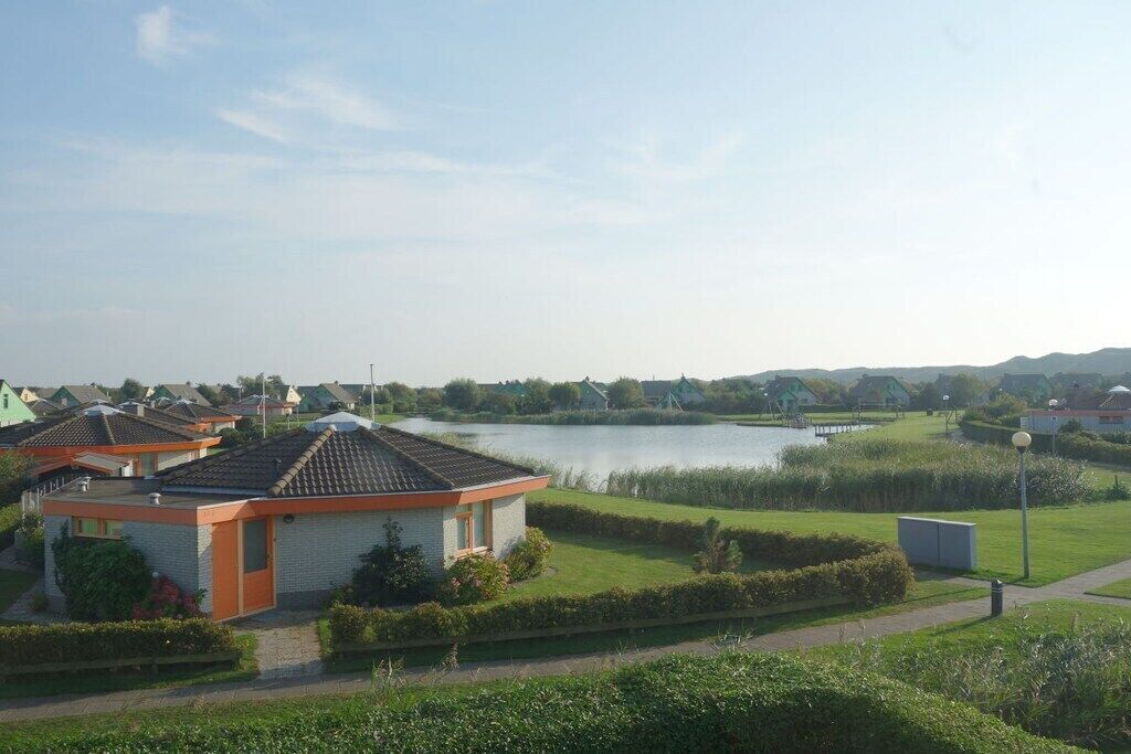 A residential area with houses, a lake, and a bridge.