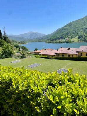 A view of a lake with buildings and greenery in the foreground.