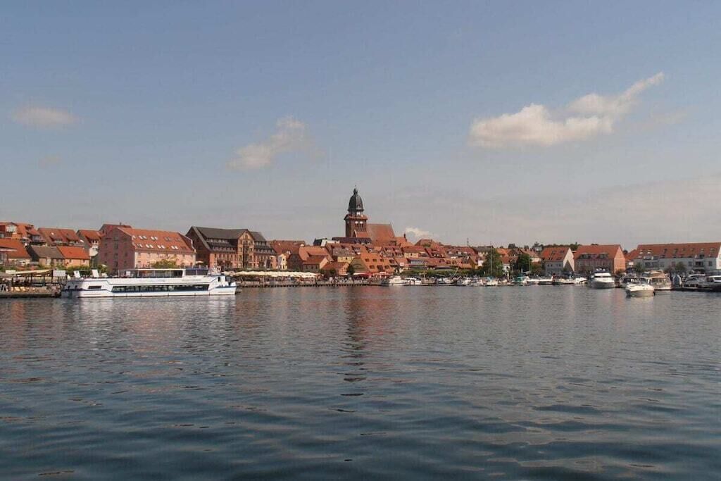 A river with a boat and buildings along the shore.