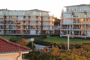 A multi-story residential building with balconies and large windows. - Strandpalais Apt. 404 (Cuxhaven-Duhnen)