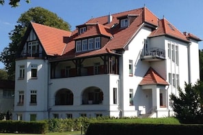 A multi-story building with a red-tiled roof, multiple balconies, and a white facade. - Holiday apartment Villa Löwenstein 319577 (Kühlungsborn)