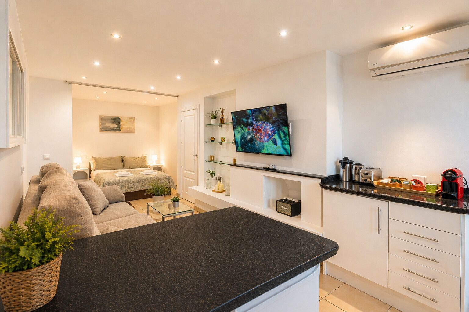 Eine moderne Wohnung mit Wohnbereich, Schlafzimmer und Küche.