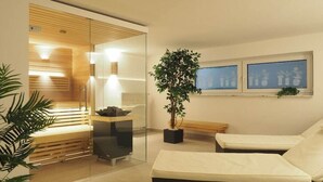 Um spa moderno com divisória de vidro, mesa de massagem, um banco e planta em vaso.