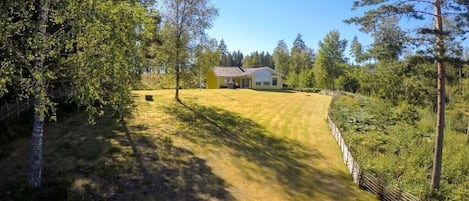 A house with a well-maintained lawn and a wooden fence.