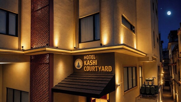 A hotel named 'Hotel Kashi Courtyard' with a sign, a staircase, and a view of the night sky. - Kashi Courtyard (Varanasi)
