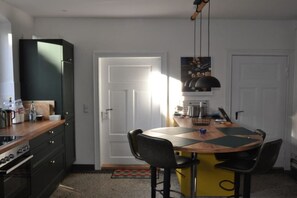 A compact kitchen with a central island, a stove, and a refrigerator. - Holiday home with 4 bedrooms (Gorlosen , OT Strassen)