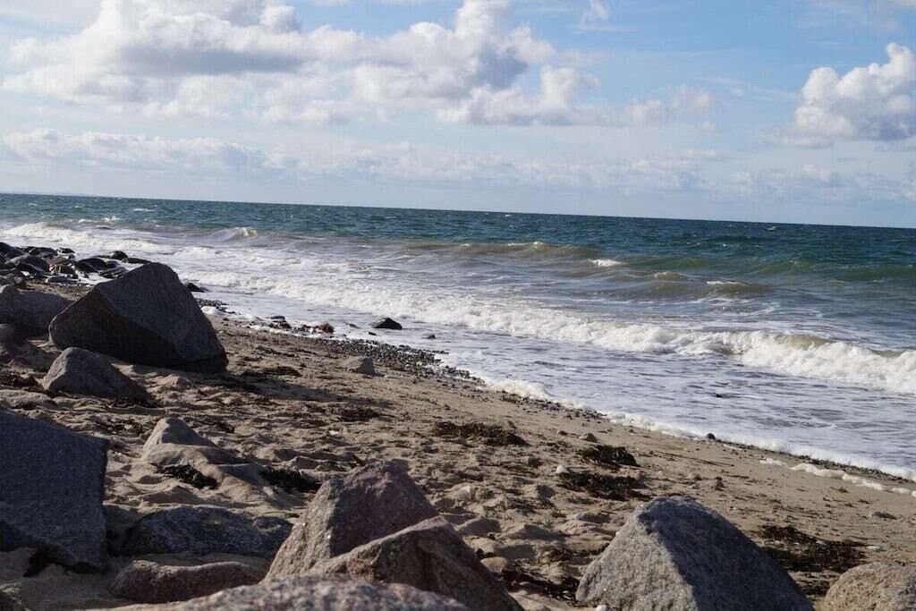 A beach with large rocks and waves.