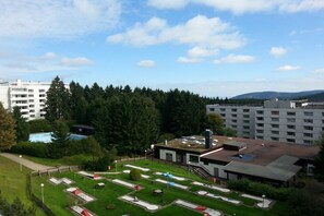 A residential area with a swimming pool, tennis courts, and a building with a flat roof. - Holiday apartment with 2 bedrooms (Goslar\/Hahnenklee)