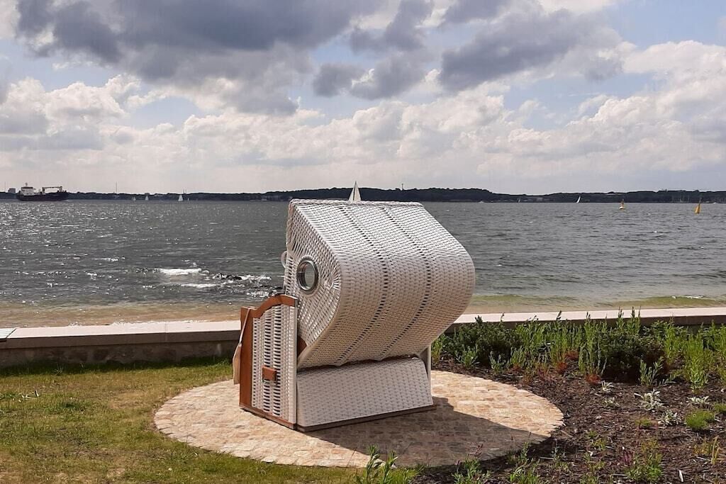A unique outdoor seating area with a circular brick platform and a distinctive white, woven structure.