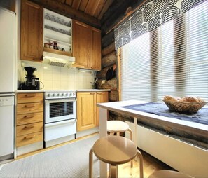 Kitchen with an electric stove and oven, a coffee maker and plenty of worktop space.