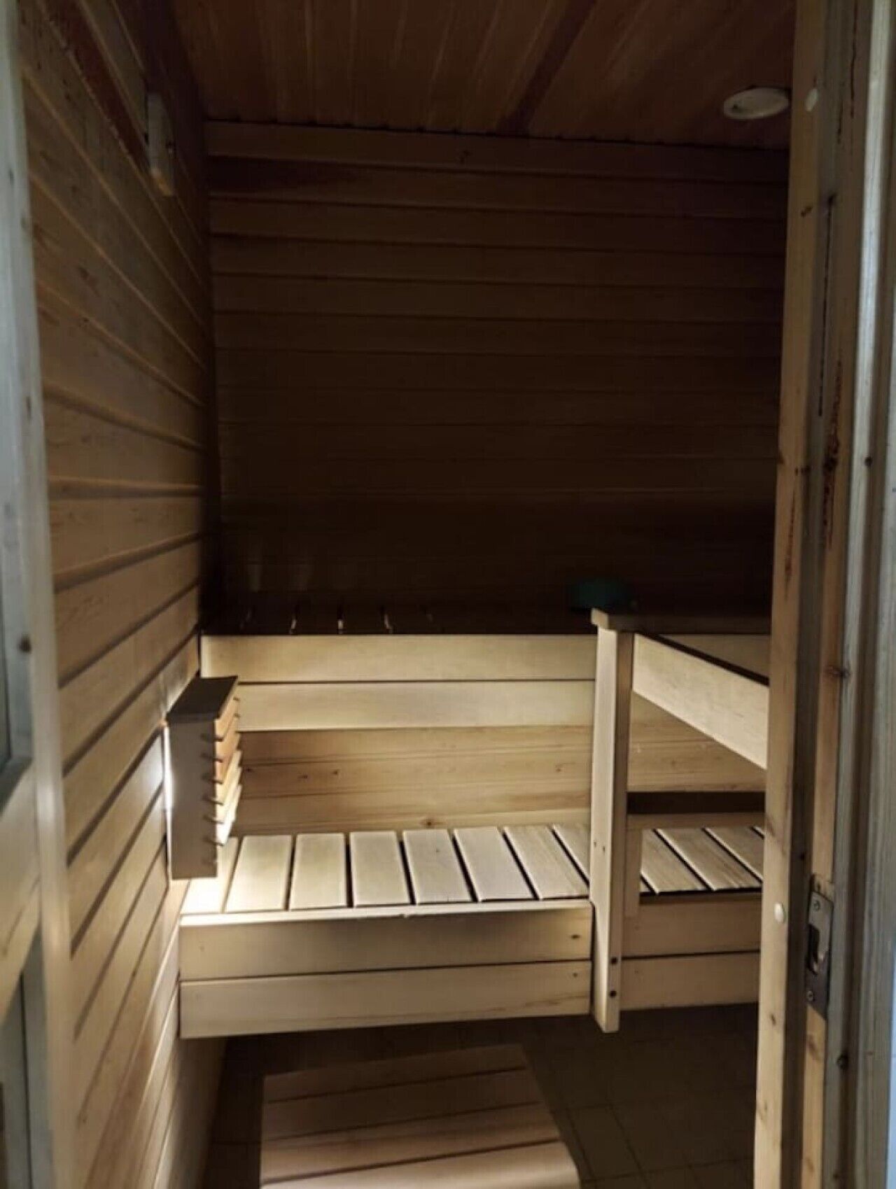 A wooden interior with a bench and a small table.