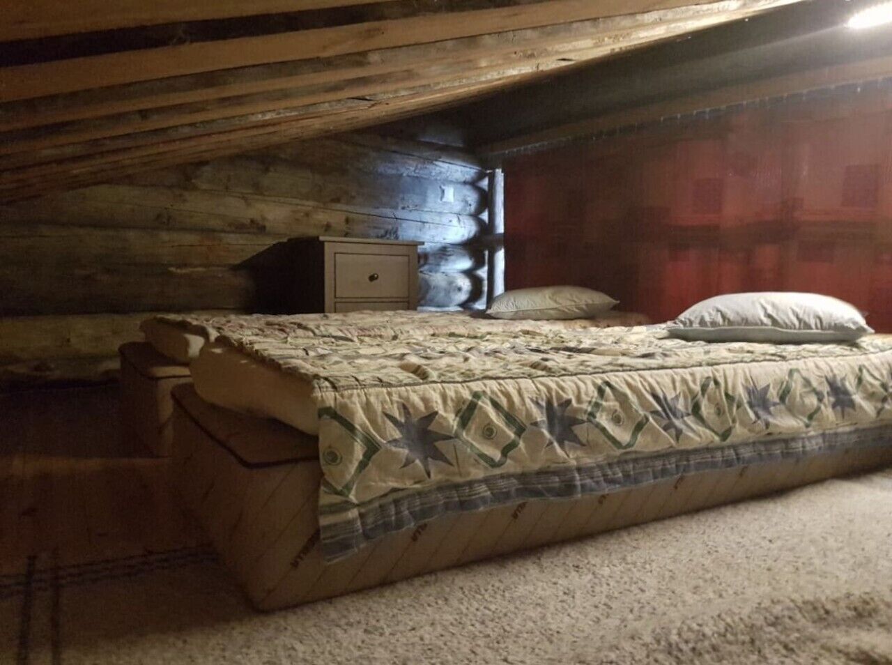 A small, cozy room with a single bed, a nightstand, and a dresser.