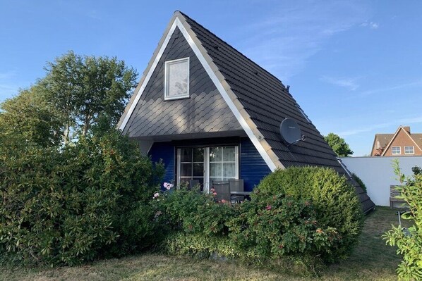 A house with a triangular roof, a satellite dish, and a window. - Holiday home with 2 bedrooms (Spieka-Neufeld (Wurster Nordseeküste))
