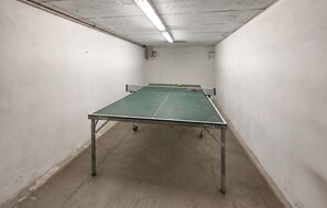 A table tennis table in a narrow hallway with white walls and a fluorescent light fixture. - 3 bedroom nice home in Skjærhalden (Skjærhalden)