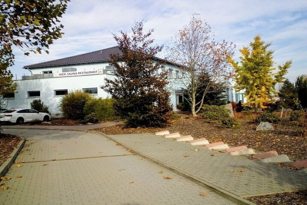 A building labeled 'MERI SAUNA RESTAURANT' with a paved pathway leading to the entrance.