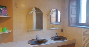 A bathroom with two sinks, a mirror above each, and a window to the right. - Detached village house with balcony, near Issoire and natural attractions (Perrier)