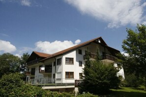 A multi-story building with balconies, surrounded by greenery. - House on the Gutach River No. 07 (Titisee- Neustadt)