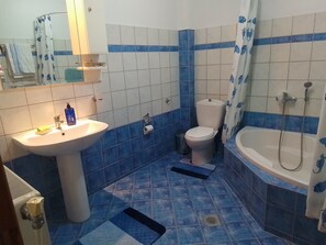 A bathroom with a sink, toilet, and bathtub.