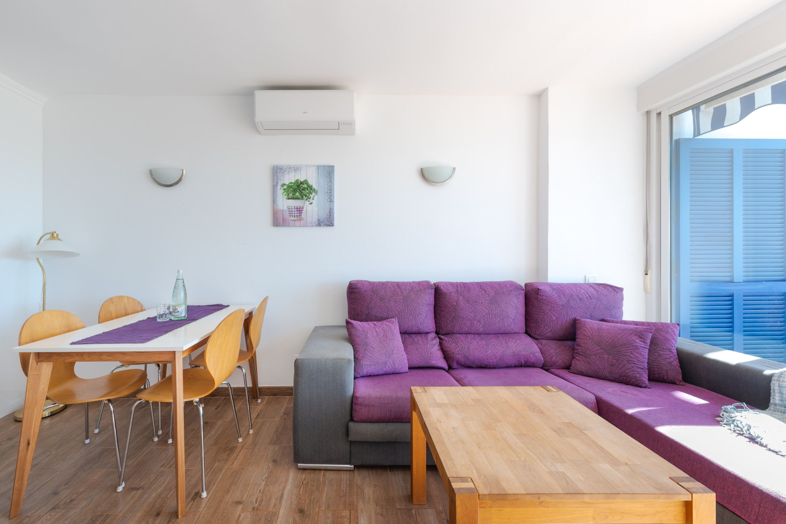 A modern living space with a dining area, a sofa, and a coffee table.