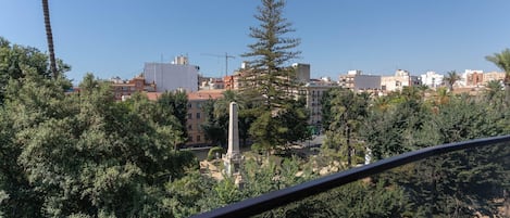 A residential area with buildings, trees, and a clear sky.