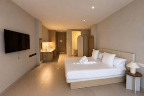 A hotel room with a large bed, a TV mounted on the wall, a bedside table with a lamp, and a bathroom with a mirror and sink. - Apartment La Plaza 2 double standard (Alicante)