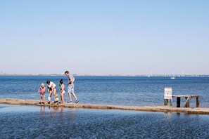 A waterfront scene with a group of people by a dock. - Beautiful villa in Colijnsplaat (Colijnsplaat)