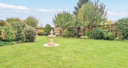 Self contained log cabin with lots of greenery