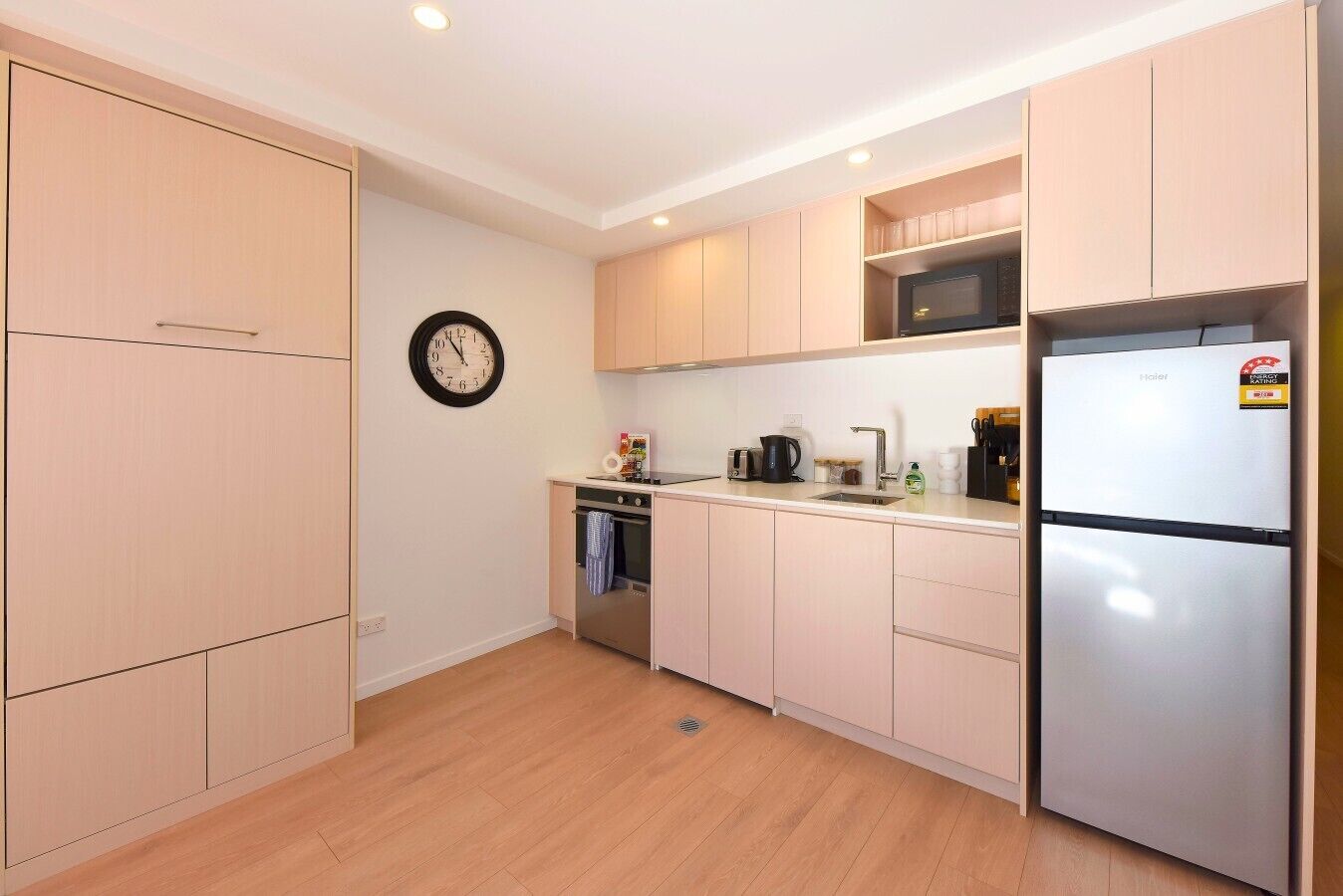 A compact kitchen with a microwave, stove, and refrigerator.