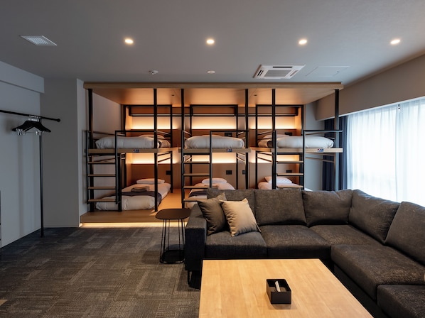 A modern interior with bunk beds, a sofa, and a coffee table.